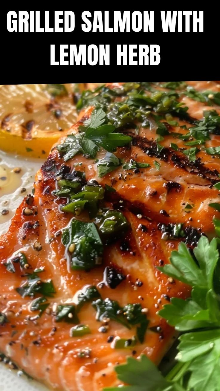 Close-up of grilled salmon with lemon and fresh herbs on a plate.