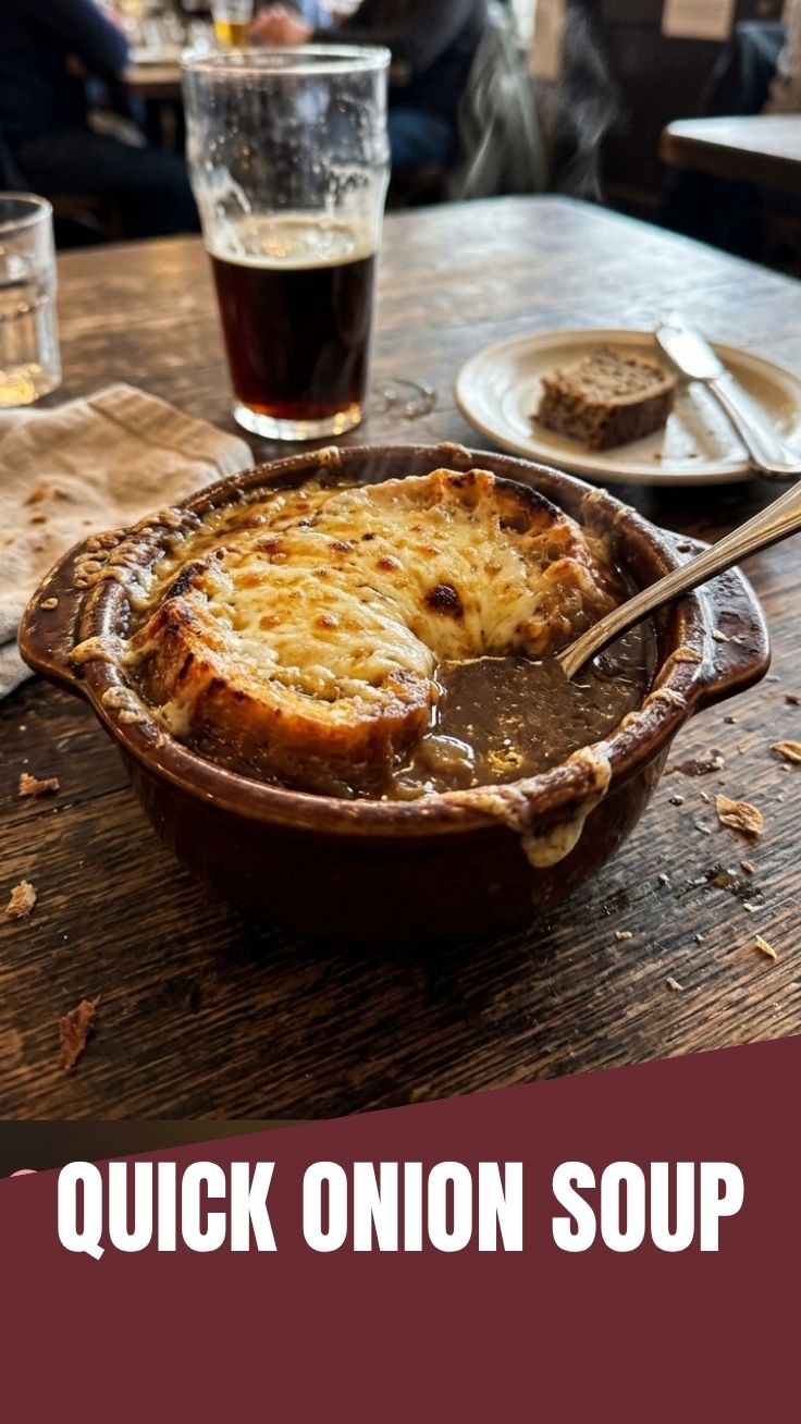 A steaming bowl of French onion soup with melted cheese and croutons