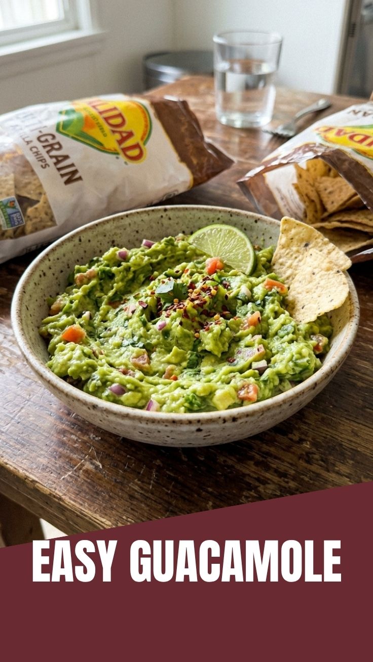 A vibrant bowl of fresh guacamole with chunky avocado and spices.