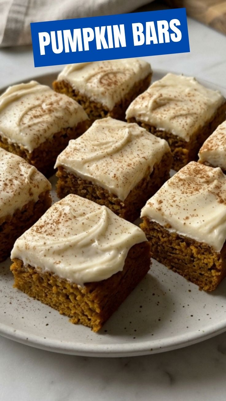 Delicious pumpkin bars with cream cheese frosting on a cooling rack