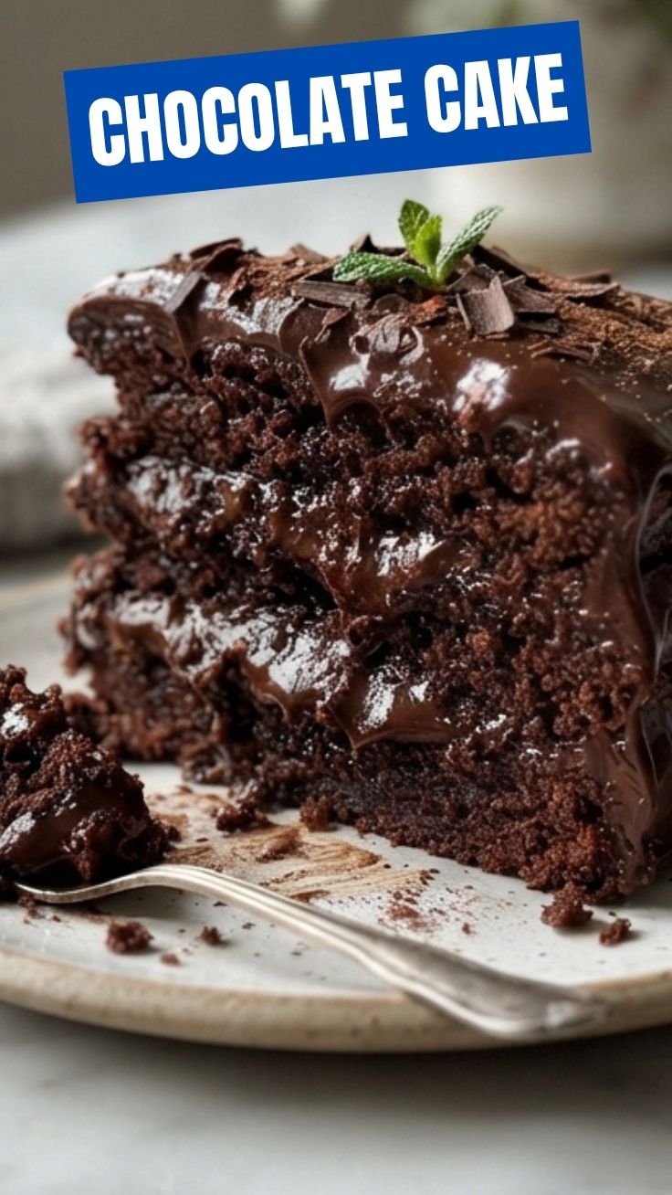 Rich chocolate cake with dark frosting on a cake stand