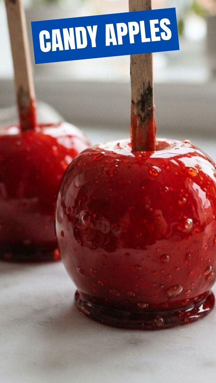 Perfectly coated candy apples and caramel apples cooling on parchment paper