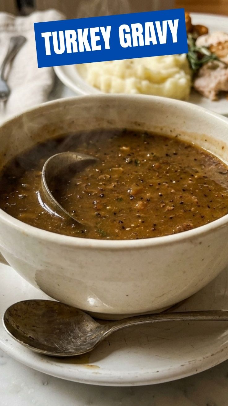 Rich, golden turkey gravy being poured over sliced white meat